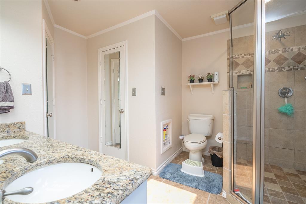116 Meadowglen Circle Coppell, TX 75019 - Photo 22 of 32 a bathroom with a granite countertop sink a toilet and shower