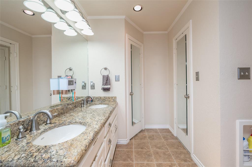 116 Meadowglen Circle Coppell, TX 75019 - Photo 23 of 32 a bathroom with a granite countertop double vanity sink a mirror and shower