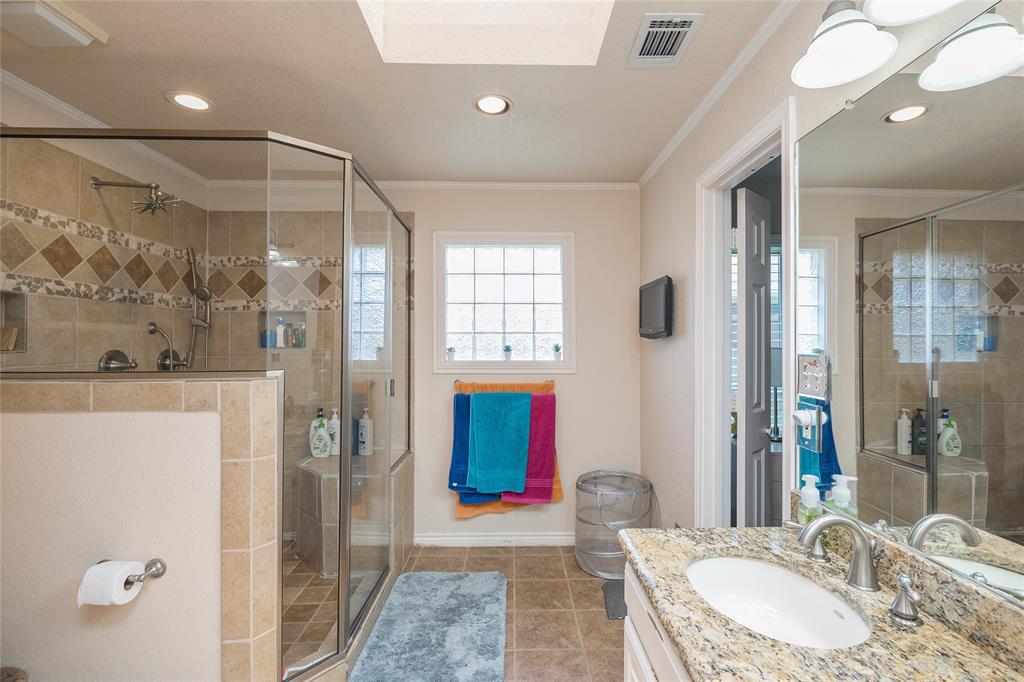 116 Meadowglen Circle Coppell, TX 75019 - Photo 24 of 32 a bathroom with a granite countertop sink a mirror and shower