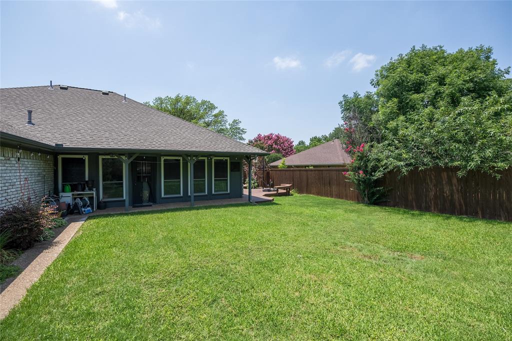 116 Meadowglen Circle Coppell, TX 75019 - Photo 29 of 32 a front view of a house with a garden and porch
