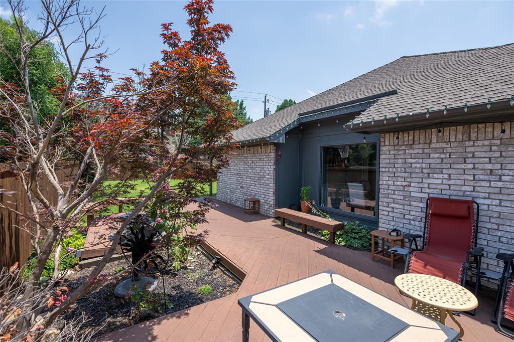 116 Meadowglen Circle Coppell, TX 75019 - Photo 32 of 32 a view of a patio with table and chairs with wooden fence and plants