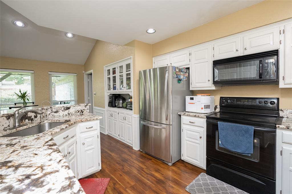 116 Meadowglen Circle Coppell, TX 75019 - Photo 7 of 32 a kitchen with stainless steel appliances a stove microwave and refrigerator