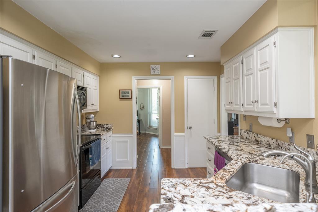 116 Meadowglen Circle Coppell, TX 75019 - Photo 9 of 32 a kitchen with stainless steel appliances granite countertop a refrigerator sink and stove