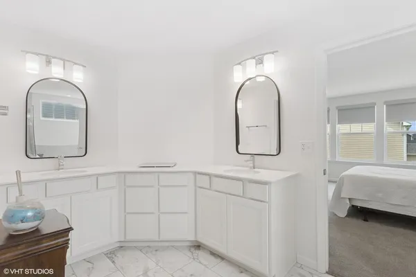 a bathroom with a sink double vanity and a mirror