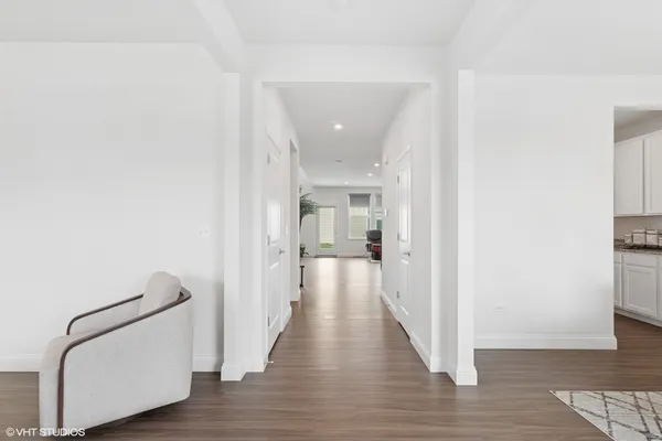 a view of a hallway with wooden floor