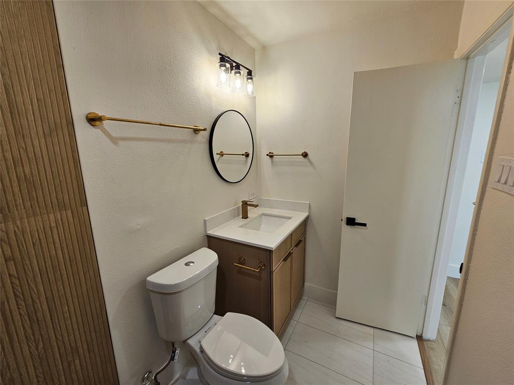 1725 R Avenue, Unit 1727 Plano, TX 75074 - Photo 11 of 20 Modern vanity with a rectangular undermount sink, brass-finish faucet, and white countertop