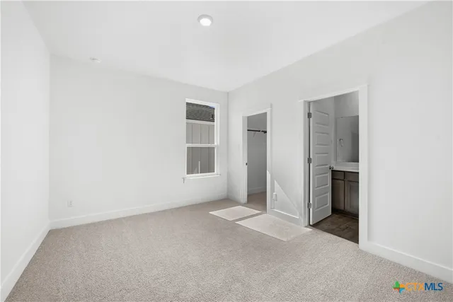 a bathroom with a sink a toilet and shower curtain