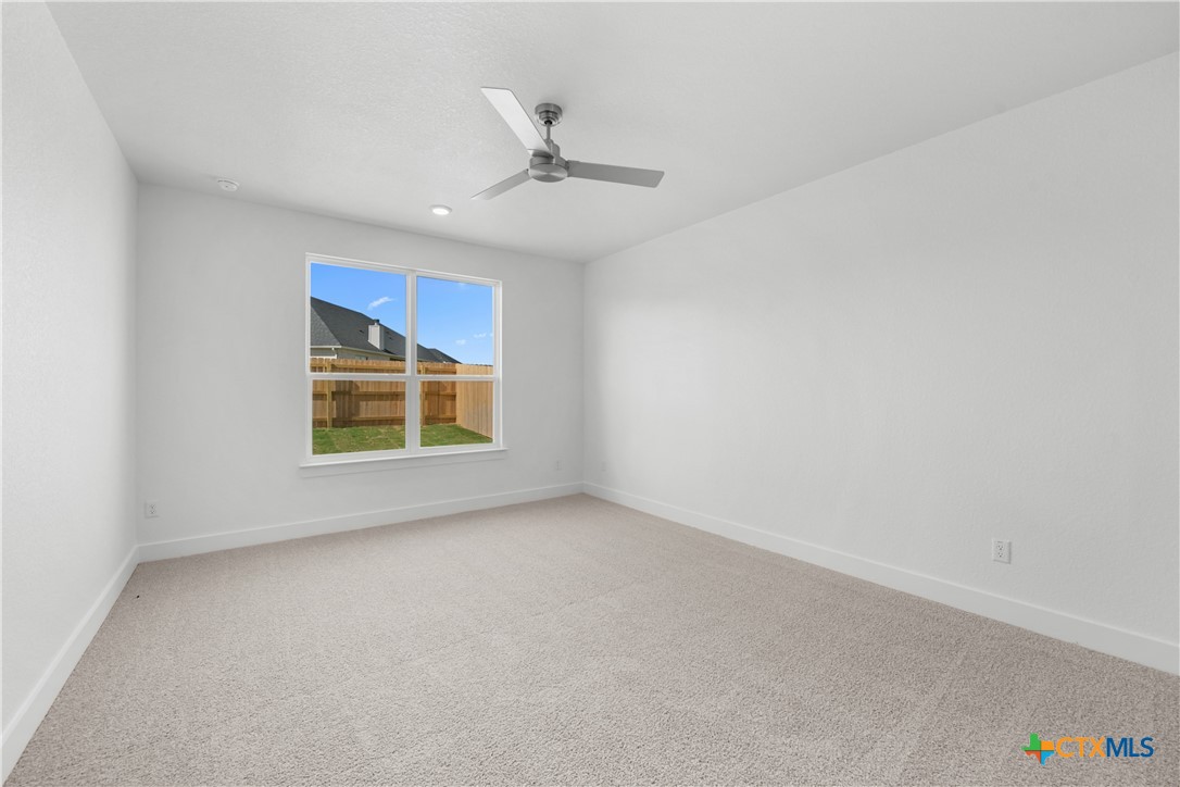 8917 Ponderosa Pine Road Temple, TX 76502 - Photo 6 of 16 an empty room with windows and fan