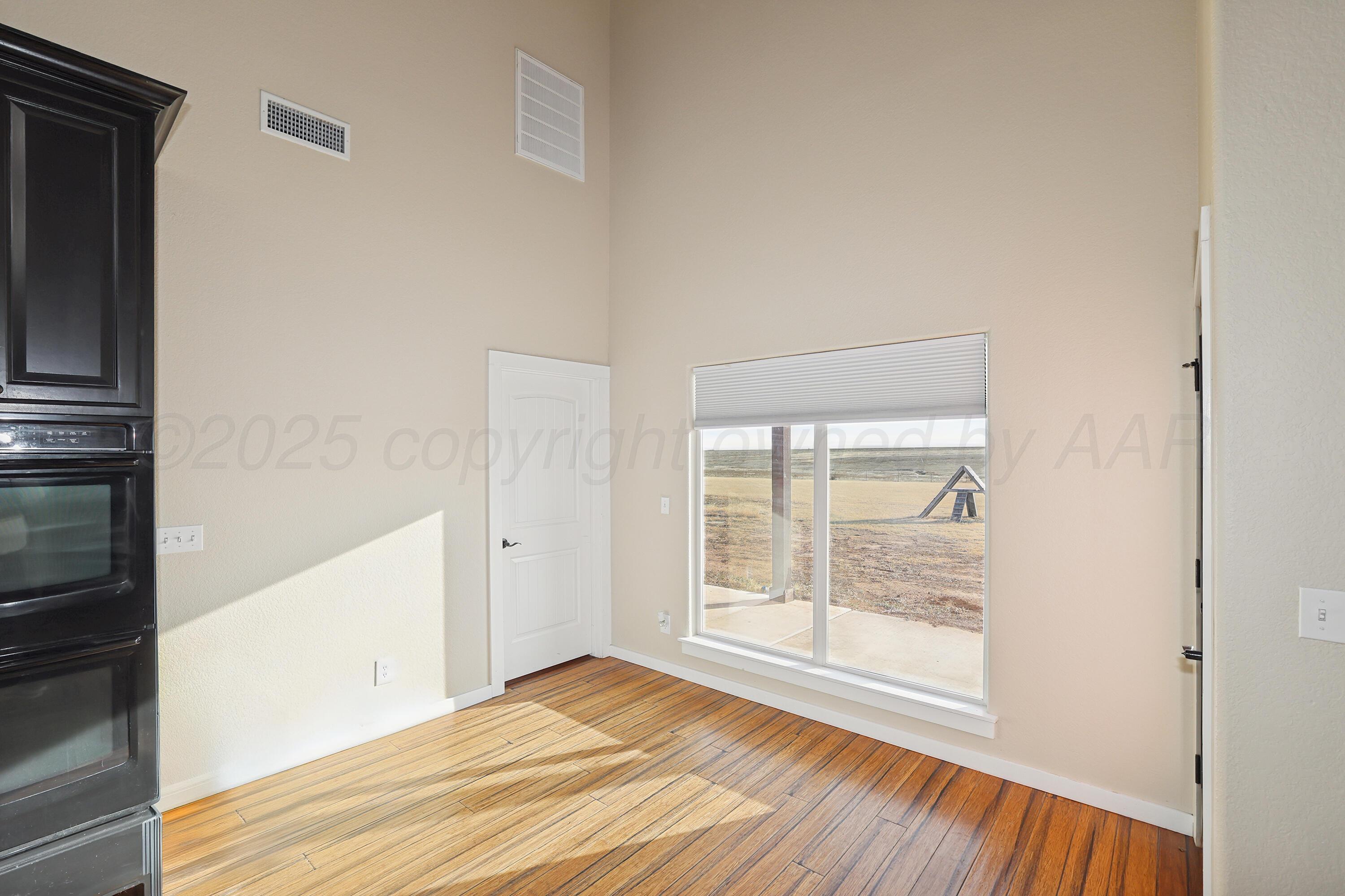 5282 County Road 8 Claude, TX 79019 - Photo 11 of 51 a view of an empty room with wooden floor and a window