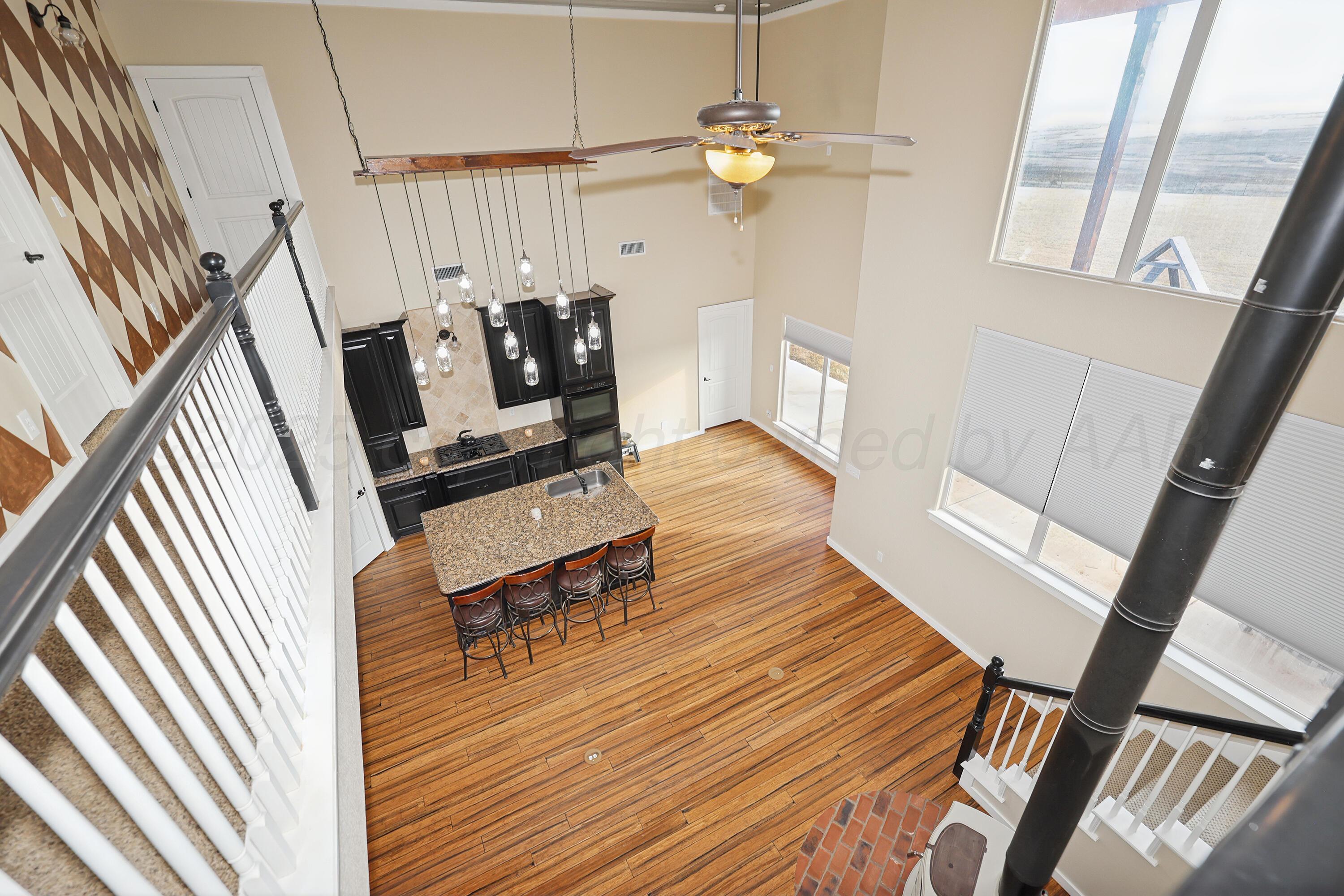 5282 County Road 8 Claude, TX 79019 - Photo 12 of 51 a living room with furniture and a chandelier