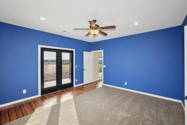 a bathroom with a granite countertop sink and a tub