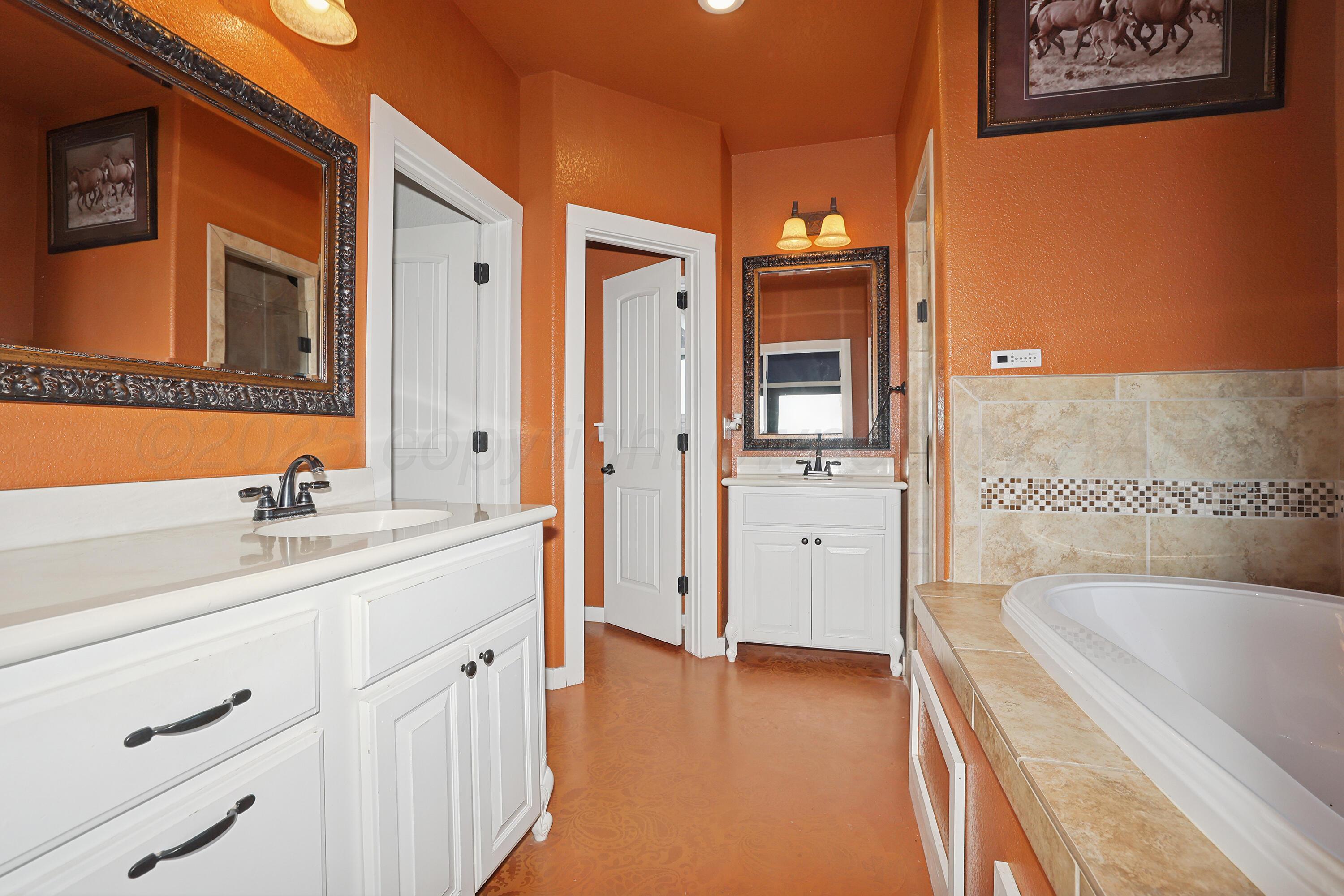 5282 County Road 8 Claude, TX 79019 - Photo 16 of 51 a bathroom with a granite countertop sink and a tub