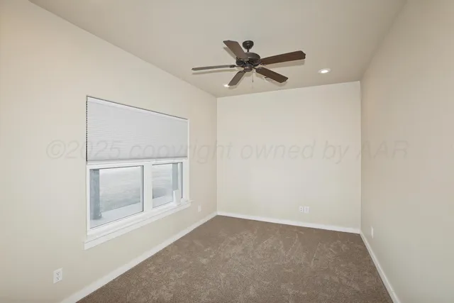 a view of a livingroom with a ceiling fan and window