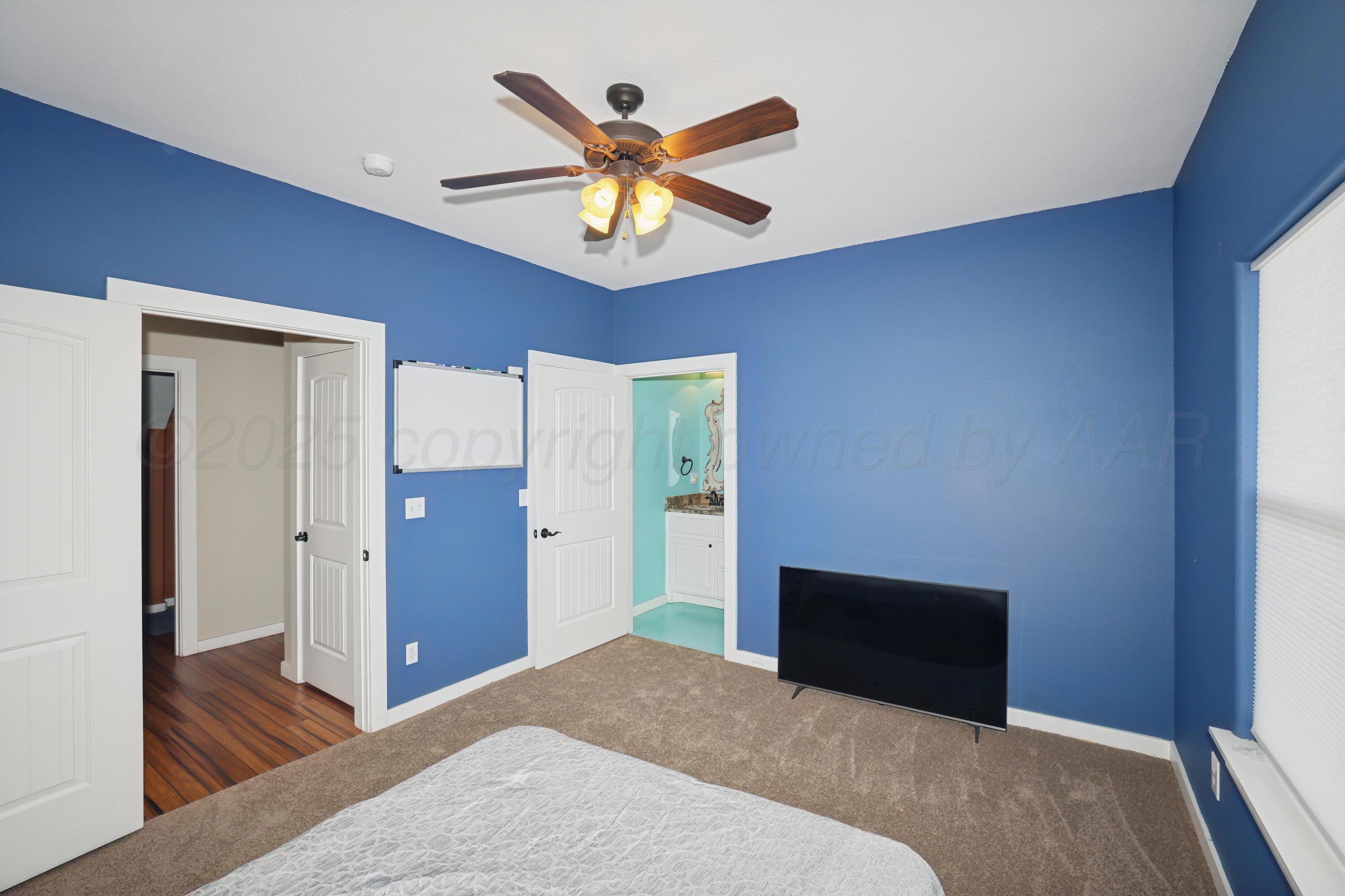 5282 County Road 8 Claude, TX 79019 - Photo 24 of 51 a bedroom with a bed and a chandelier