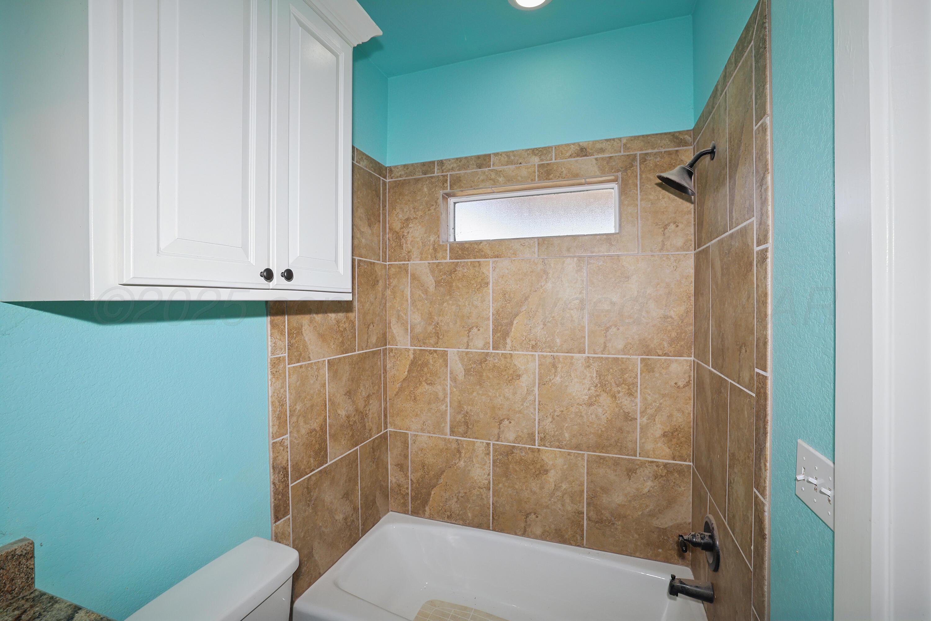 5282 County Road 8 Claude, TX 79019 - Photo 27 of 51 a bathroom with a toilet and a shower