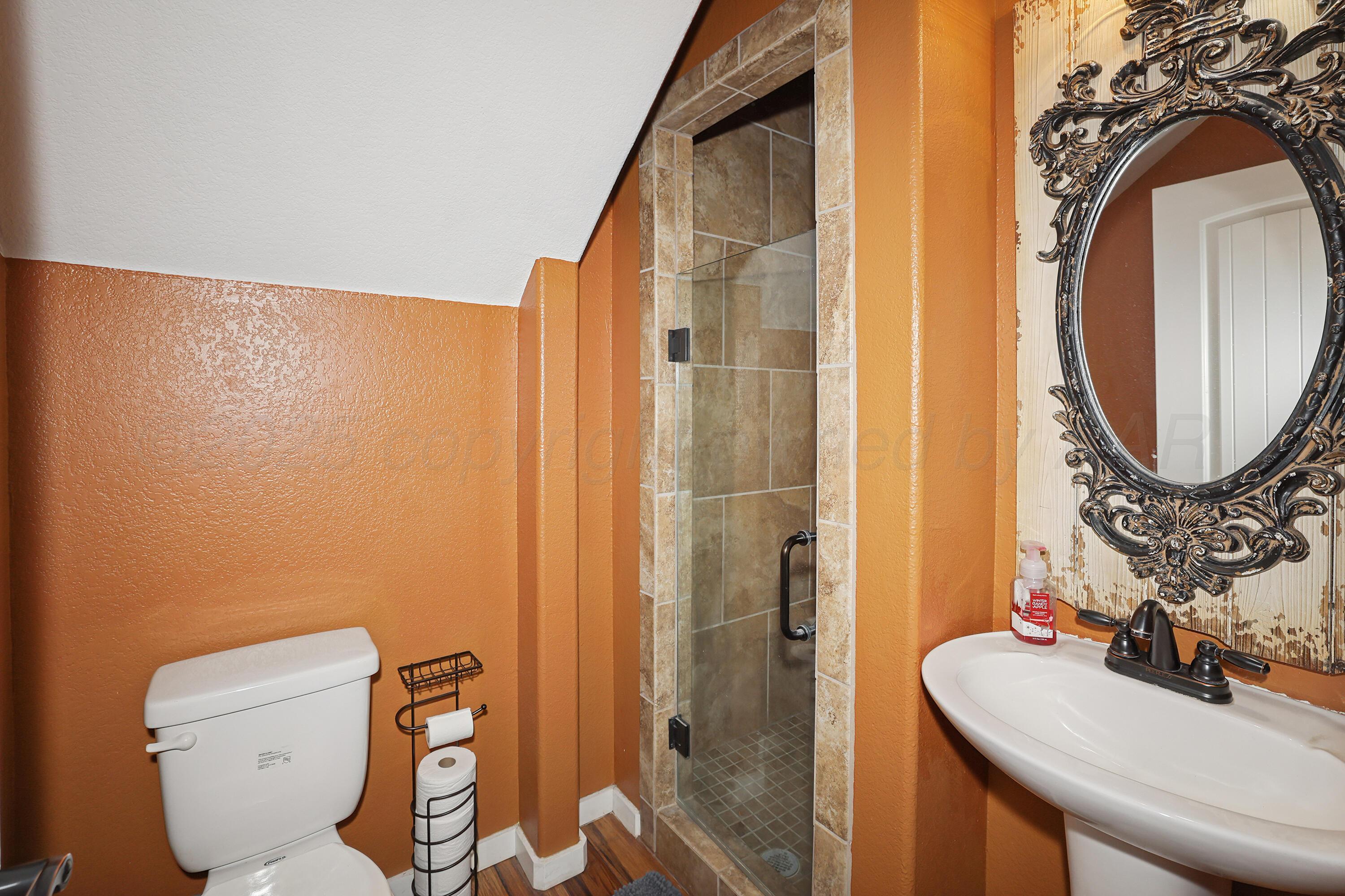 5282 County Road 8 Claude, TX 79019 - Photo 28 of 51 a bathroom with a toilet sink and mirror