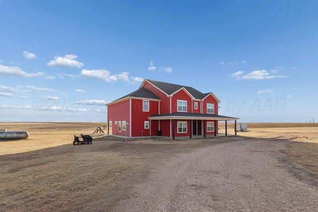a view of a house with outdoor space and ocean view