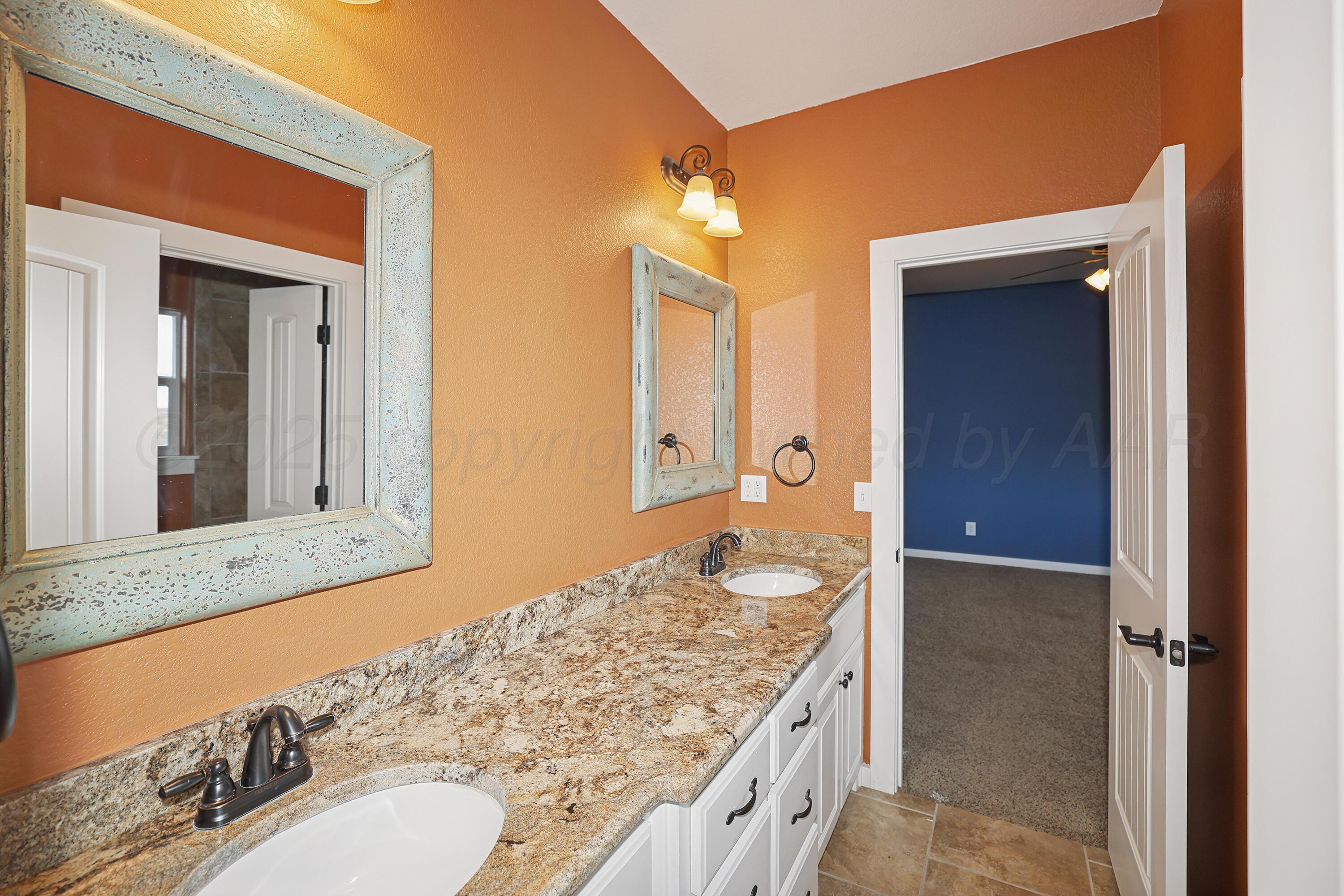 5282 County Road 8 Claude, TX 79019 - Photo 35 of 51 a bathroom with a granite countertop sink and a mirror