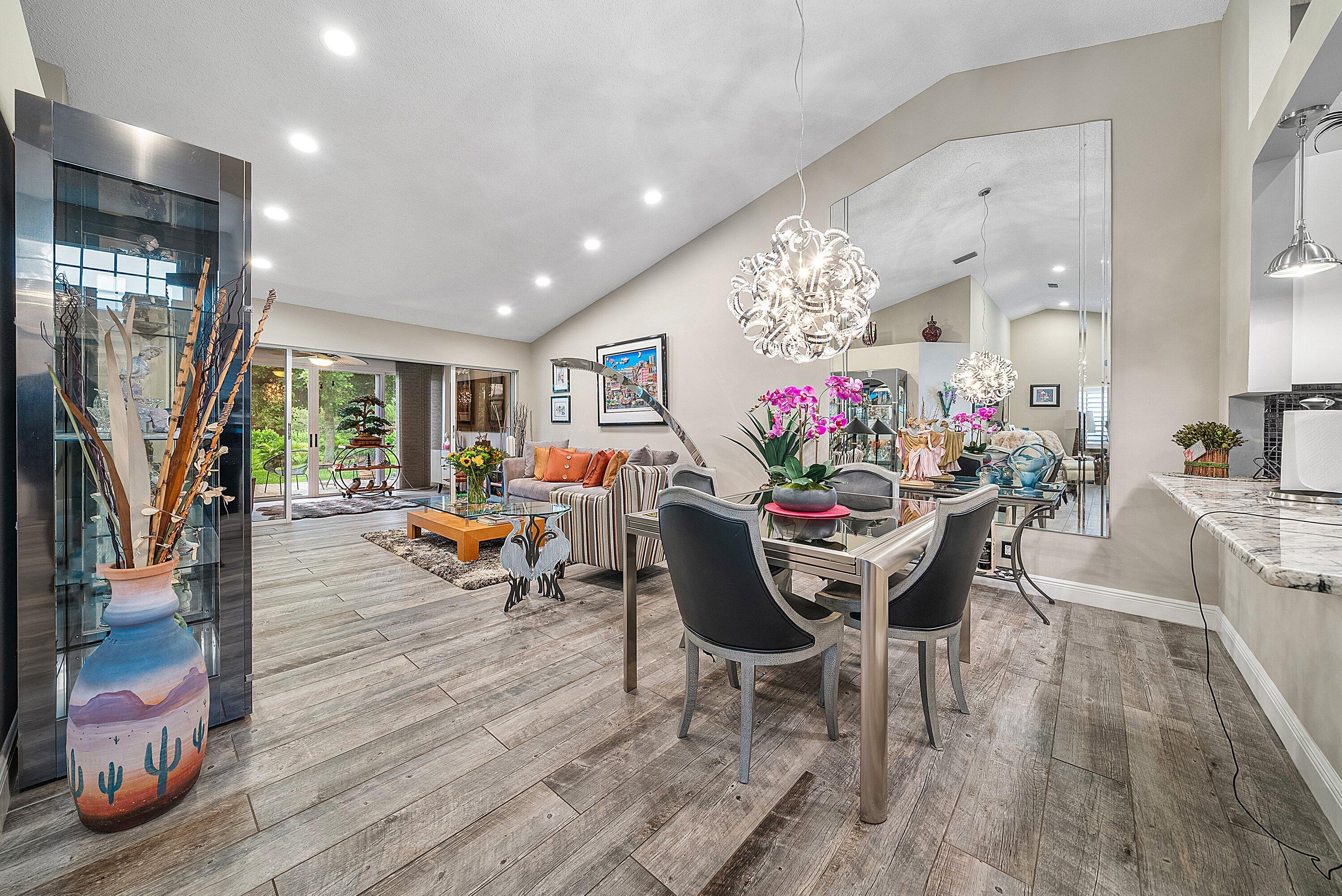 14338 Ruby Pointe Drive Delray Beach, FL 33446 - Photo 14 of 36 a view of a dining room with furniture and a chandelier