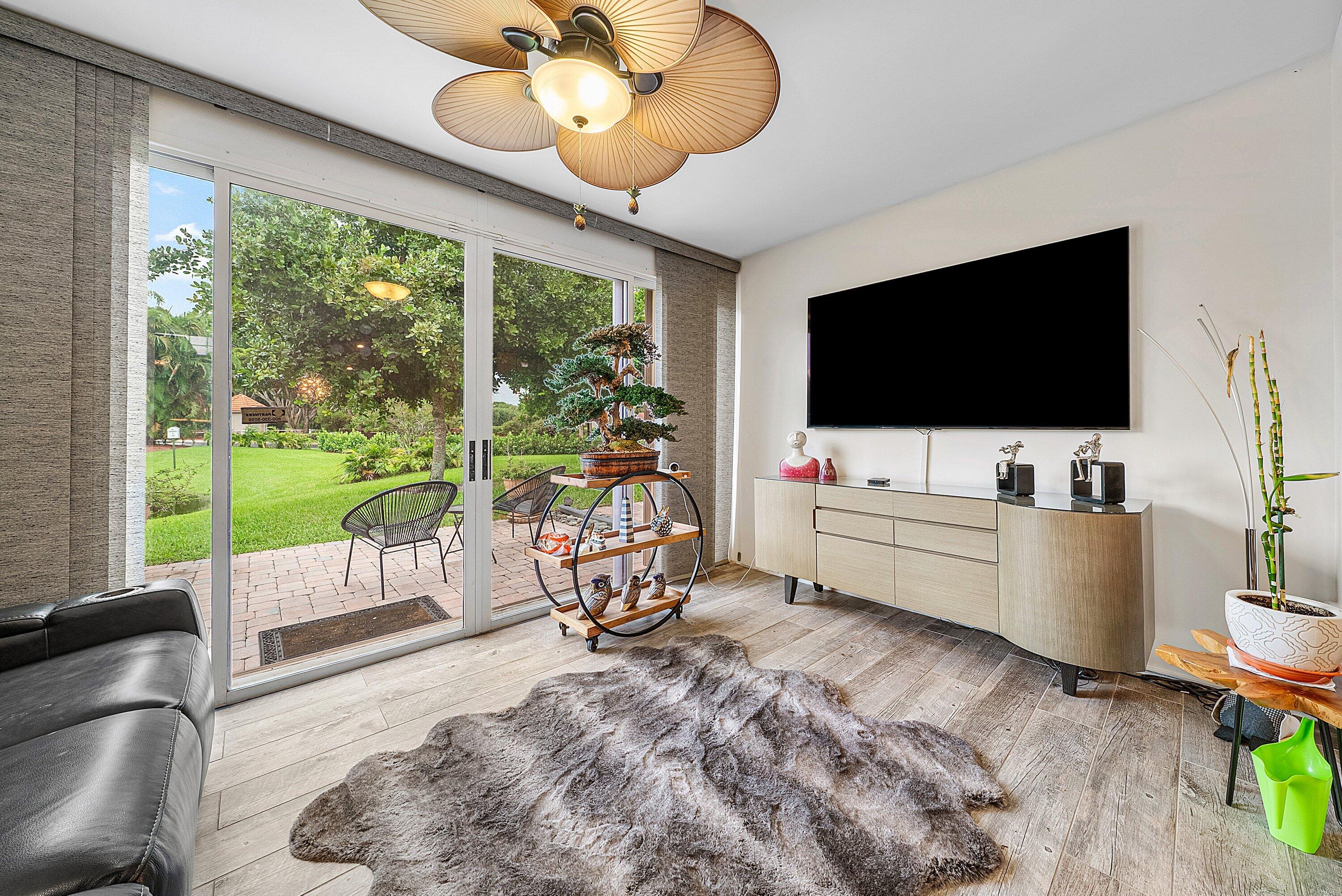 14338 Ruby Pointe Drive Delray Beach, FL 33446 - Photo 20 of 36 a living room with furniture and a flat screen tv