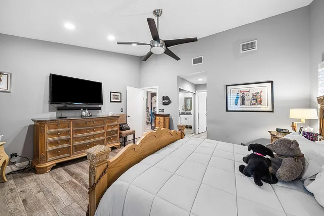 a bedroom with a bed and a flat screen tv