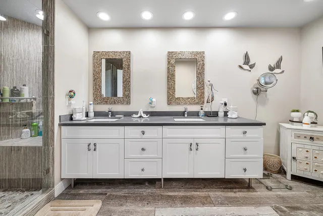 a bathroom with a double vanity sink and a mirror