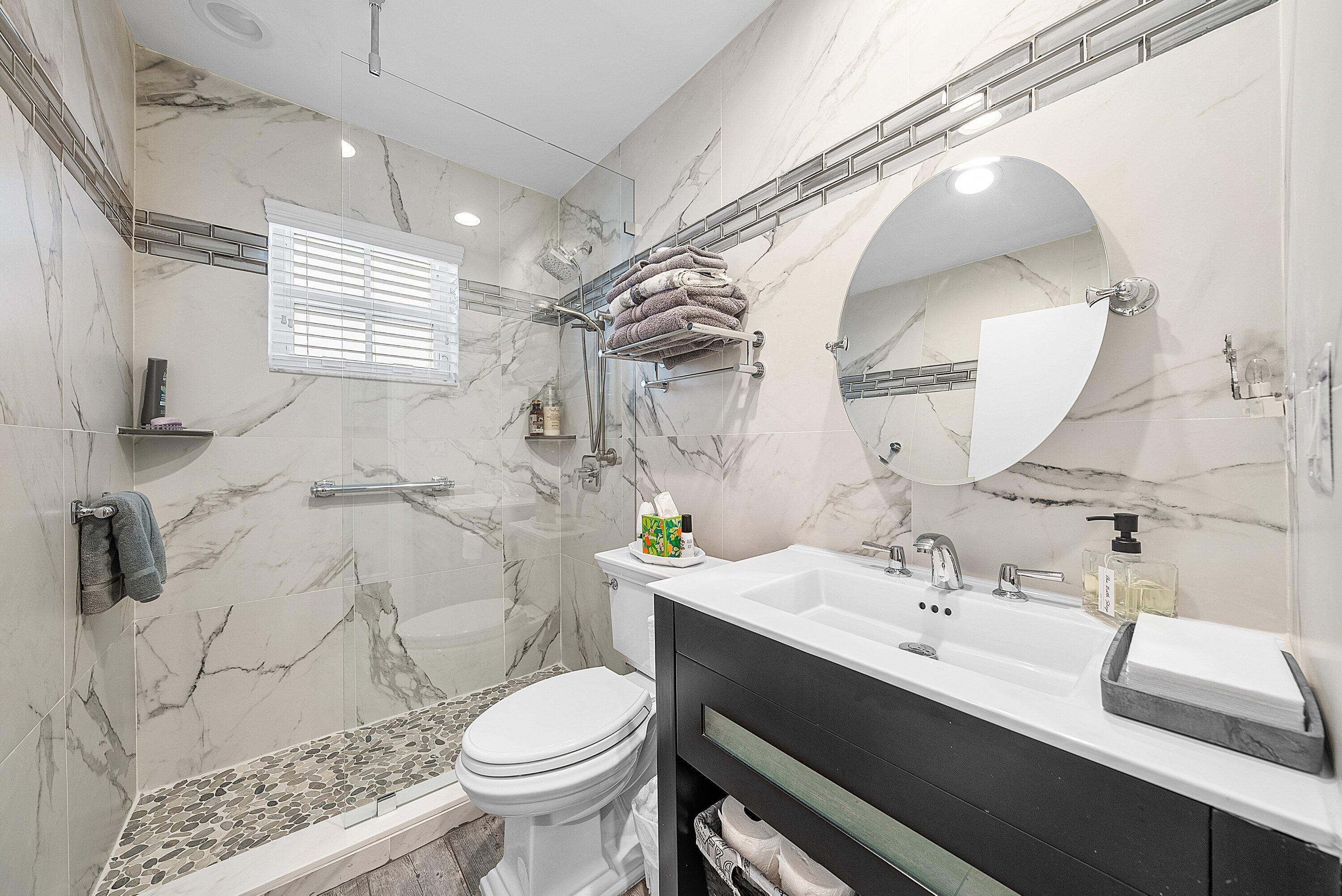 14338 Ruby Pointe Drive Delray Beach, FL 33446 - Photo 29 of 36 a bathroom with a sink a toilet and a mirror