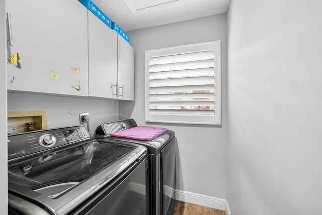 a kitchen with a stove cabinets and a window