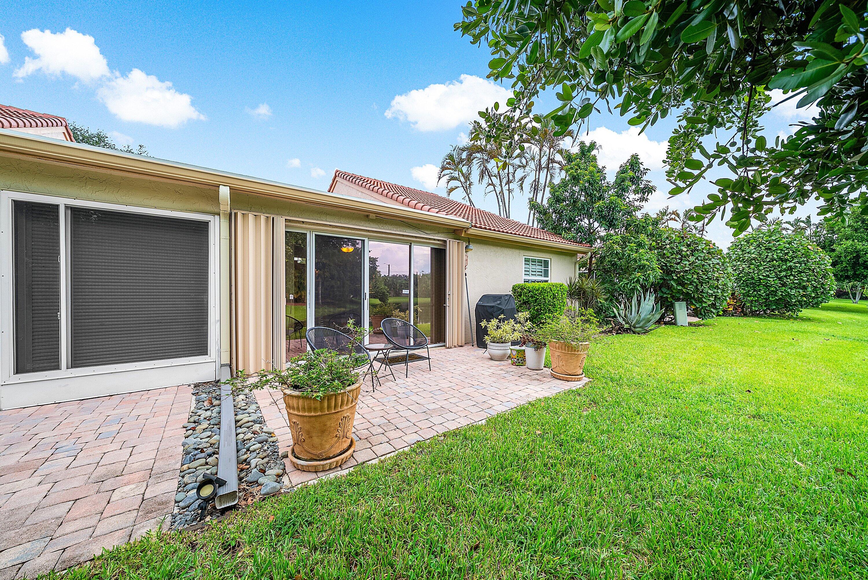 14338 Ruby Pointe Drive Delray Beach, FL 33446 - Photo 34 of 36 a view of a chair and table in backyard of the house