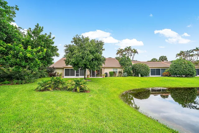 a view of a house with yard and a garden