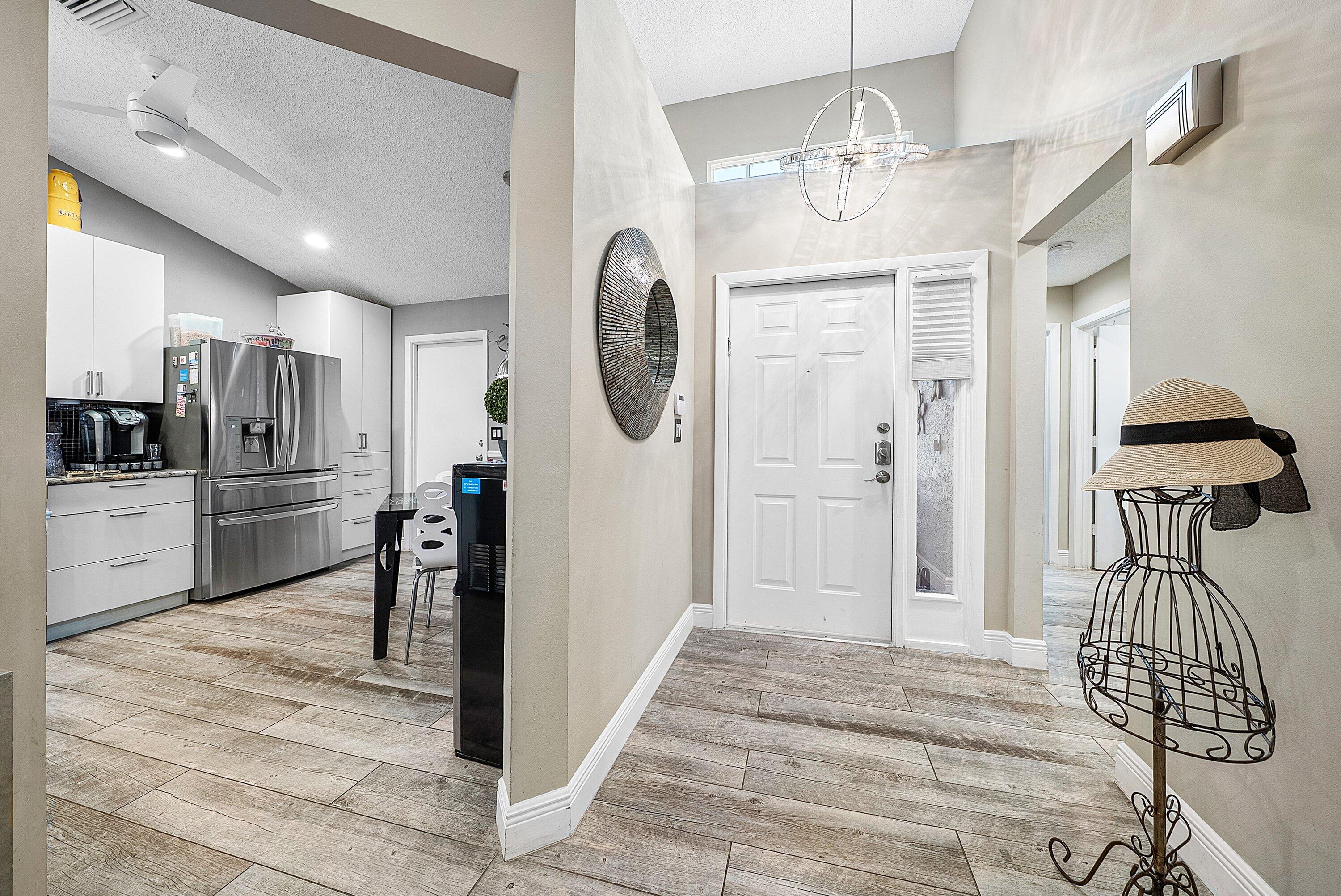 14338 Ruby Pointe Drive Delray Beach, FL 33446 - Photo 5 of 36 a kitchen with stainless steel appliances granite countertop a refrigerator and a sink