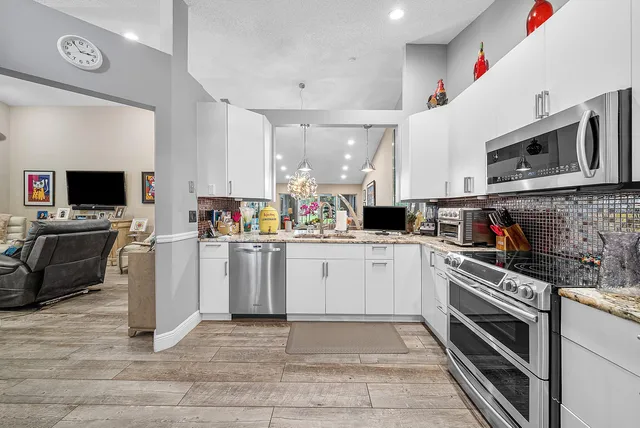 a kitchen with a sink cabinets and stainless steel appliances