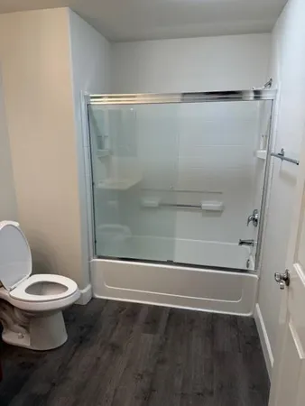 a bathroom with a shower and a toilet