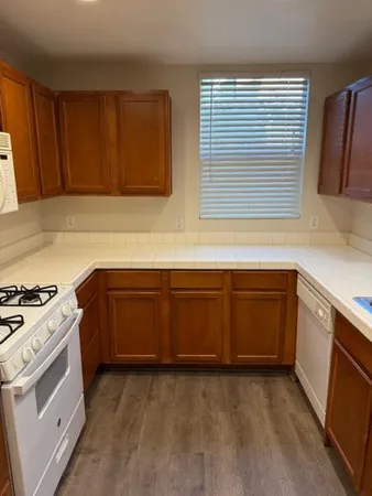a kitchen with wooden cabinets and a stove top oven