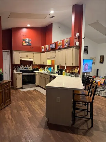 a kitchen with stainless steel appliances kitchen island granite countertop a sink and cabinets