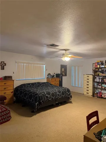 a bedroom with bed and window