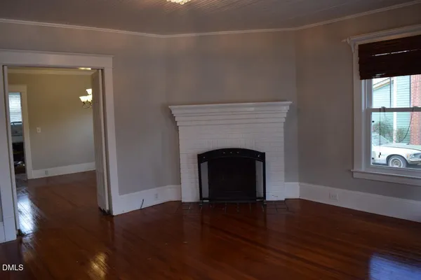 a view of a livingroom with a fireplace and window