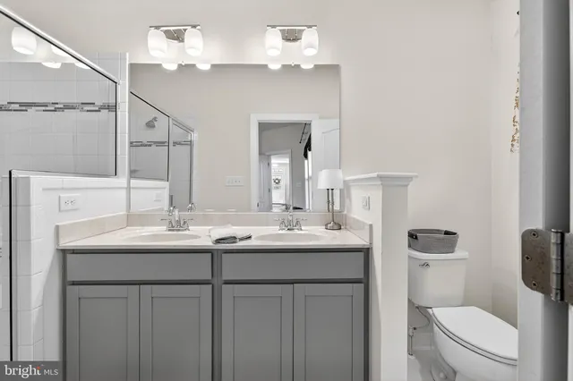 a bathroom with a toilet a sink and mirror