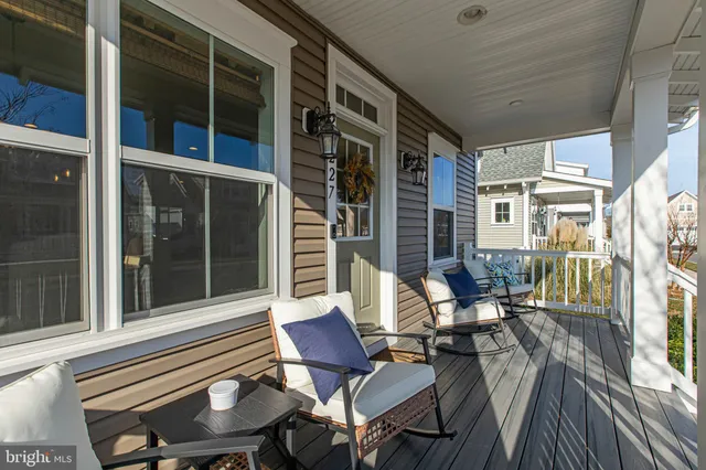 a balcony with table and chairs