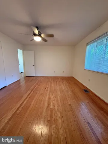 a view of room with hardwood floor and ceiling fan