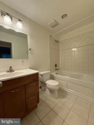 a bathroom with a toilet a sink a mirror and a bathtub