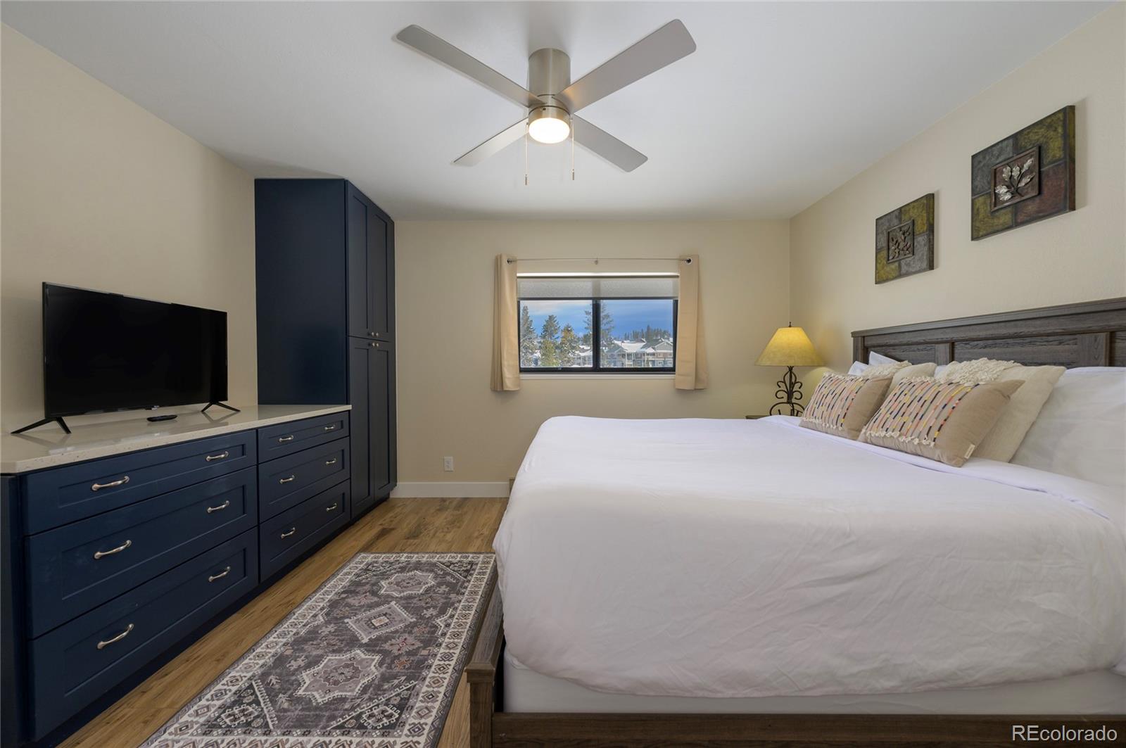 83 County Road, Unit F7 Fraser, CO 80442 - Photo 10 of 20 a bedroom with a bed and a flat screen tv