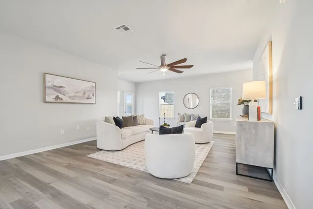 a living room with furniture and a large window