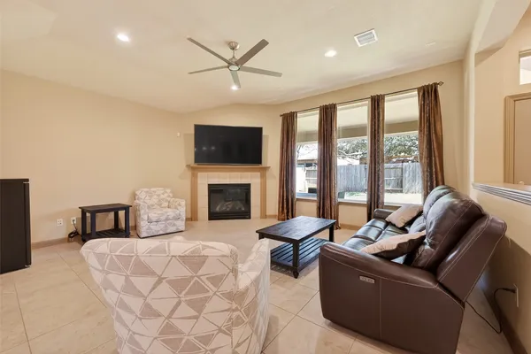 a living room with couches and a flat screen tv with wooden floor