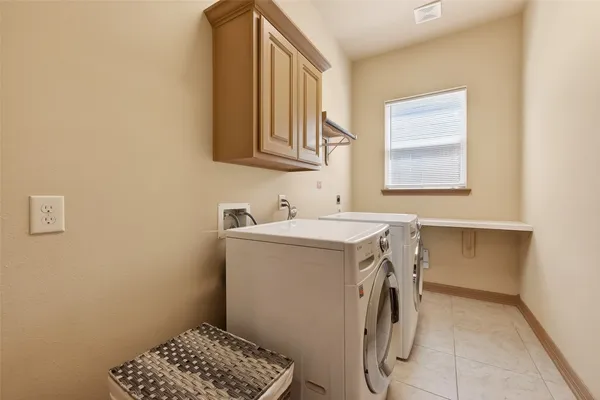 an empty room with wooden floor ceiling fan and windows