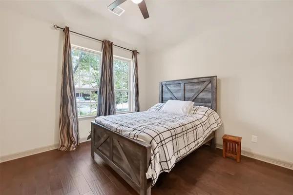 a bedroom with a large bed and a window