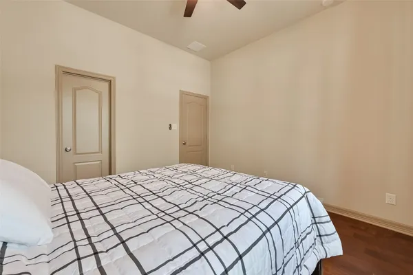 a bathroom with a granite countertop sink a toilet a mirror and bathtub