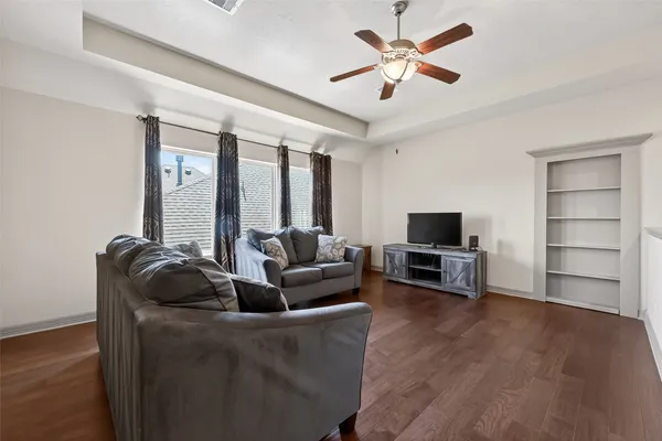 a view of a backyard with a garden and tree