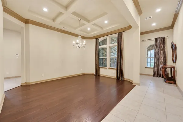 a large kitchen with granite countertop a large counter top a sink stainless steel appliances and cabinets