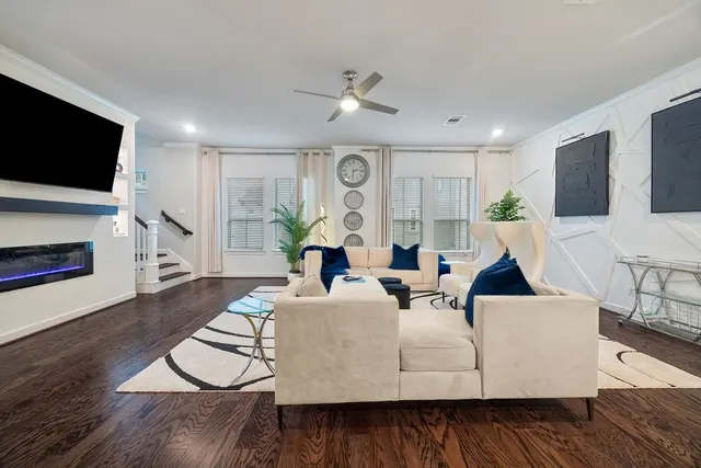 a living room with stainless steel appliances kitchen island granite countertop a dining table chairs and view kitchen